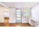 Bright living room with a built in desk and drawers next to front door and large window at 4803 Brae Burn Ave, Sarasota, FL 34234