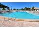Large community pool with crystal clear blue water and various chairs for residents to enjoy at 4803 Brae Burn Ave, Sarasota, FL 34234