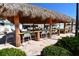 Outdoor tiki bar featuring a thatched roof, wooden bar, and seating perfect for gatherings at 4803 Brae Burn Ave, Sarasota, FL 34234