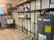 Practical utility room with storage shelves, sink, water heater, and durable flooring at 4803 Brae Burn Ave, Sarasota, FL 34234
