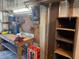 Organized workshop featuring a workbench, pegboard for tools, shelving, and ample lighting at 4803 Brae Burn Ave, Sarasota, FL 34234