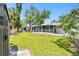 View of the expansive yard, showcasing the screened porch and peaceful surroundings at 4803 Brae Burn Ave, Sarasota, FL 34234