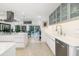 Sleek kitchen with a modern faucet and stainless steel dishwasher, enhanced by ample countertop space and an open design at 494 Sapphire Dr, Sarasota, FL 34234