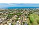 Stunning aerial view of a neighborhood with golf course, bay, and gorgeous landscaping around the home at 504 Whitfield Ave, Sarasota, FL 34243