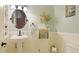 Charming powder room with a pedestal sink, decorative mirror, and quaint decor creating a welcoming ambiance at 504 Whitfield Ave, Sarasota, FL 34243