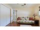 Cozy bedroom featuring wood floors, a futon, and a double door closet, providing ample storage space at 504 Whitfield Ave, Sarasota, FL 34243