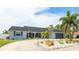 Front elevation of a lovely single-story home with meticulously landscaped front yard and ample parking at 504 Whitfield Ave, Sarasota, FL 34243