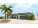 Charming single-story home featuring a well-maintained lawn, mature palms, and a neutral painted facade at 504 Whitfield Ave, Sarasota, FL 34243
