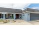 Inviting exterior view featuring a well-manicured landscape and a covered entry at 504 Whitfield Ave, Sarasota, FL 34243