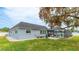 Beautiful home exterior featuring a screened-in pool area, lush landscaping, and a well-maintained lawn at 504 Whitfield Ave, Sarasota, FL 34243