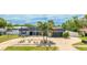 Charming single-story home boasts a beautiful front yard, mature palms, and well-maintained landscaping at 504 Whitfield Ave, Sarasota, FL 34243
