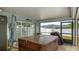 A spacious screened-in lanai features a covered hot tub, exterior access to the yard, and ample space for relaxation at 504 Whitfield Ave, Sarasota, FL 34243