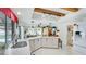 Eat-in kitchen featuring a breakfast bar, white cabinetry, stainless appliances and open floorplan at 504 Whitfield Ave, Sarasota, FL 34243