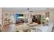 Comfortable living room featuring hardwood floors, ample seating, and a large screen TV at 504 Whitfield Ave, Sarasota, FL 34243
