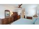 Bright and airy main bedroom featuring tropical decor, white trim, and a view to the ensuite bathroom at 504 Whitfield Ave, Sarasota, FL 34243