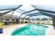 Lovely outdoor space with pool, outdoor dining and lounging furniture under screened enclosure with views of the house and yard at 504 Whitfield Ave, Sarasota, FL 34243