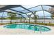 Relaxing screened-in pool area with a large pool and a peaceful outdoor setting at 504 Whitfield Ave, Sarasota, FL 34243
