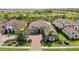 Stunning aerial view of home showcasing tile roof, landscaping and brick driveway at 5313 Greenbrook Dr, Sarasota, FL 34238