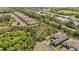 An aerial view of a neighborhood showing a walking path through the dense trees at 5313 Greenbrook Dr, Sarasota, FL 34238