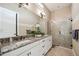Bathroom featuring a double vanity, granite countertops, and glass-enclosed shower at 5313 Greenbrook Dr, Sarasota, FL 34238
