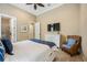 Comfortable bedroom featuring neutral walls, a ceiling fan, and charming decor creating a serene and inviting space at 5313 Greenbrook Dr, Sarasota, FL 34238