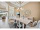 Open-concept dining area with modern chandelier, coastal decor, and natural light at 5313 Greenbrook Dr, Sarasota, FL 34238
