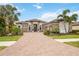 Beautiful single-story home with stone accents, a paver driveway and well-maintained landscaping at 5313 Greenbrook Dr, Sarasota, FL 34238