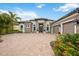 Beautiful single-story home with stone accents, a paver driveway and well-maintained landscaping at 5313 Greenbrook Dr, Sarasota, FL 34238