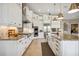 Modern kitchen featuring custom cabinets, granite countertops, stainless steel appliances, and a long kitchen island at 5313 Greenbrook Dr, Sarasota, FL 34238