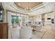 Bright and airy living room with a high ceiling, modern chandelier, and large sliding glass doors to the outdoor patio at 5313 Greenbrook Dr, Sarasota, FL 34238