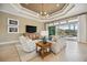 Bright and airy living room with neutral tones, sliding doors to outdoors, and recessed lighting at 5313 Greenbrook Dr, Sarasota, FL 34238