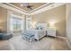 Serene main bedroom with tray ceiling, sitting area, and large windows at 5313 Greenbrook Dr, Sarasota, FL 34238