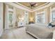 Bright main bedroom with large windows, ceiling fan, and neutral decor for a relaxing retreat at 5313 Greenbrook Dr, Sarasota, FL 34238