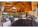 Inviting outdoor dining area with ample seating, bar access, and a view of lush landscaping at 5313 Greenbrook Dr, Sarasota, FL 34238