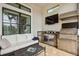 Relaxing outdoor living space with stainless steel grill, bar, and seating at 5313 Greenbrook Dr, Sarasota, FL 34238