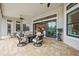Covered outdoor patio with seating area, ceiling fans, and sliding door access to the kitchen and living room at 5313 Greenbrook Dr, Sarasota, FL 34238