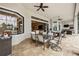 Covered outdoor patio with dining and lounge areas, ceiling fans, and serene views at 5313 Greenbrook Dr, Sarasota, FL 34238