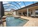 Inviting backyard pool and jacuzzi area with screened-in patio at 5313 Greenbrook Dr, Sarasota, FL 34238