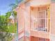 Elevated entry featuring a white-railed porch, textured walls, and a storm door with patriotic decor at 5500 Longwood Run Blvd # 201, Sarasota, FL 34243