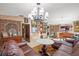 Spacious living room featuring decorative lighting, large windows and open access to other rooms at 5500 Longwood Run Blvd # 201, Sarasota, FL 34243