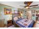 Cozy bedroom features a decorated ceiling fan and an adjacent bathroom entrance at 5500 Longwood Run Blvd # 201, Sarasota, FL 34243