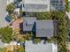 Aerial view of a home with a new gray roof, brick driveway, large backyard, and a wooden deck at 5512 Avenida Del Mare, Sarasota, FL 34242