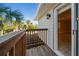 Balcony with wooden railings that has a view of nearby trees, accessible from the home's interior at 5512 Avenida Del Mare, Sarasota, FL 34242