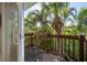 Balcony with wood railings overlooking palm trees at 5512 Avenida Del Mare, Sarasota, FL 34242
