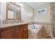 Cozy bathroom featuring a soaking tub with tile surround, a vanity with granite countertop, and a shower at 5512 Avenida Del Mare, Sarasota, FL 34242