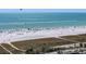 Expansive beach view with clear blue water, white sand, and recreational activities at 5512 Avenida Del Mare, Sarasota, FL 34242