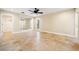 Spacious bedroom with travertine tile flooring, a ceiling fan, and a large mirror at 5512 Avenida Del Mare, Sarasota, FL 34242