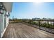 Spacious wooden deck with railing, offering stunning views of the surrounding cityscape and clear blue skies at 5512 Avenida Del Mare, Sarasota, FL 34242