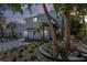 Beautiful two-story home featuring a lush garden, paver driveway, and a charming pergola entrance at 5512 Avenida Del Mare, Sarasota, FL 34242