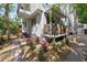 Charming exterior with well-maintained landscaping, red brick walkway, and tasteful shrubbery beneath a small porch at 5512 Avenida Del Mare, Sarasota, FL 34242